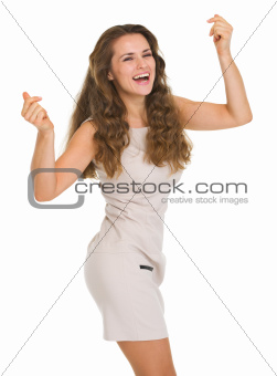 Happy young woman in dress dancing