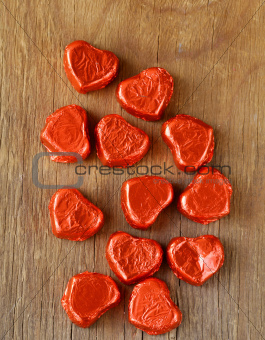 chocolates in  heart shape on a wooden background
