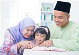 Muslim family reading book