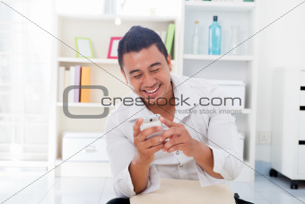 Asian male using smartphone