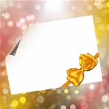 Paper with bow on bokeh lights abstract background