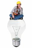 Female laborer sitting on a light bulb