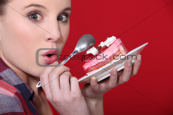 girl indulging in a piece of delicious strawberry cake