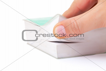 Person thumbing the pages of a book