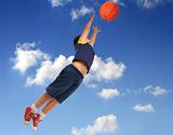Boy playing basketball. Flying with blue sky