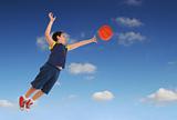 Boy playing basketball jumping and flying