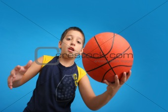 Boy playing basketball. Blue background