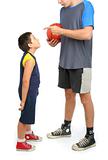 little boy asking big man to play basketball 