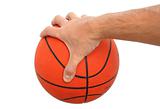Hand holding a basketball ball isolated