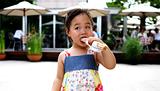 Young Asian girl having a snack