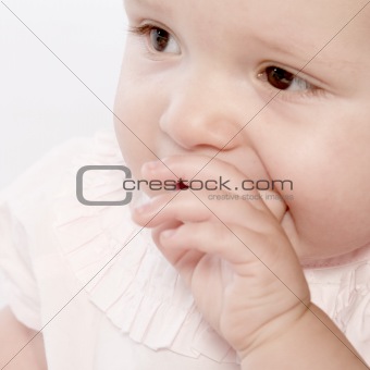 Toddler with a hand in her mouth