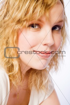 Studio portrait of a curly blond female