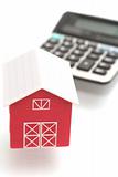 The red house and the calculator on a white background