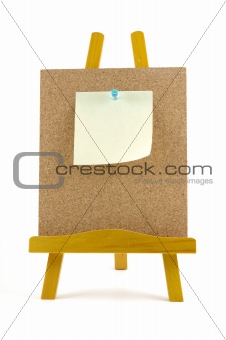 Pinned note on corkboard with wooden stand