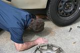 Mechanic Looks Under Car