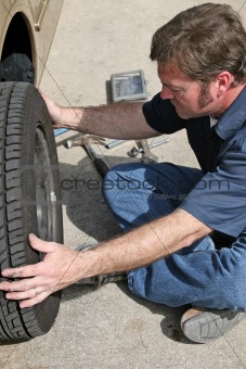 Mechanic Removing Tire