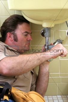 Plumber Using Pipe Wrench