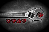 Five grunge hearts with wrench