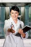Smiling medical doctor with stethoscope. Over hospital backgroun