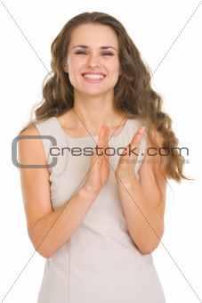 Smiling young woman applauding