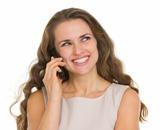 Smiling woman talking mobile phone and looking on copy space