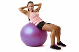 Young woman doing situps on ball