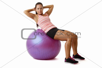Young woman doing situps on ball