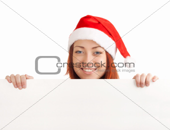 Young man in santa hat holding a blank sign