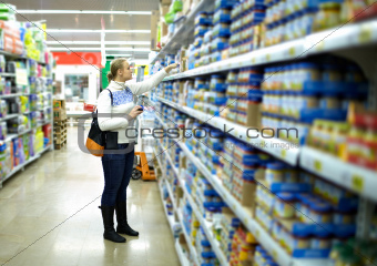 Woman in the supermarket. Kid's food.