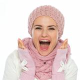 Surprised young woman in knit winter clothing
