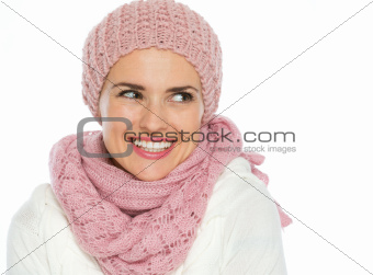Portrait of happy woman in knit scarf, hat and mittens looking on copy space