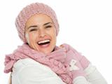 Portrait of smiling woman in knit scarf, hat and mittens