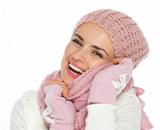 Happy young woman in winter clothes enjoying knit scarf