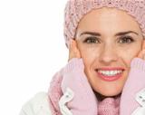 Closeup on happy woman in knit scarf and mittens