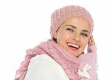 Smiling woman in knit winter clothes looking back on copy space