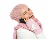 Happy woman in knit winter clothing speaking mobile