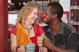Smiling Mixed Couple Having Coffee