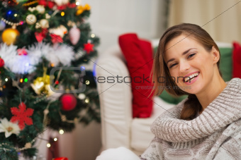 Portrait of happy woman near Christmas tree