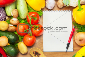 Organic Vegetables on Wooden Background and Notebook