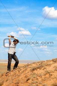 man throwing laptop outdoors