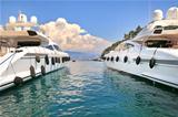 Two white luxury yachts on Mediterranean sea.