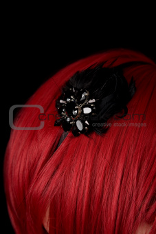 Close-up shot of black hair fascinator on red hair 