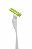 celery stalk on fork against white