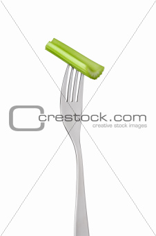 celery stalk on fork against white