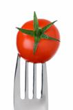 tomato on a fork on white
