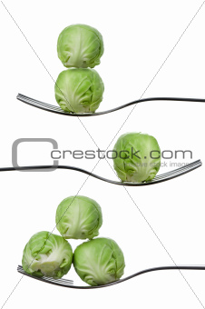 balancing brussel sprouts on forks against white
