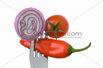 onion red chili pepper and tomato on a fork