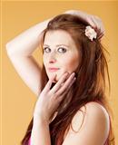  portrait of a young beautiful woman with brown hair - isolated on yellow