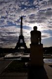 Backlit Eiffel Tower with statue