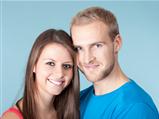 portrait of a happy young couple smiling, looking - isolated on blue